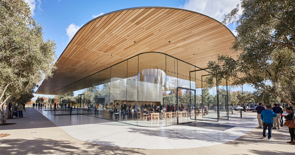 Apple Park Visitor Center with glass facade in Cupertino, California.