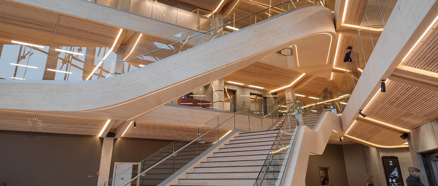 Stainless steel and glass stair escalators inside the office building from below.