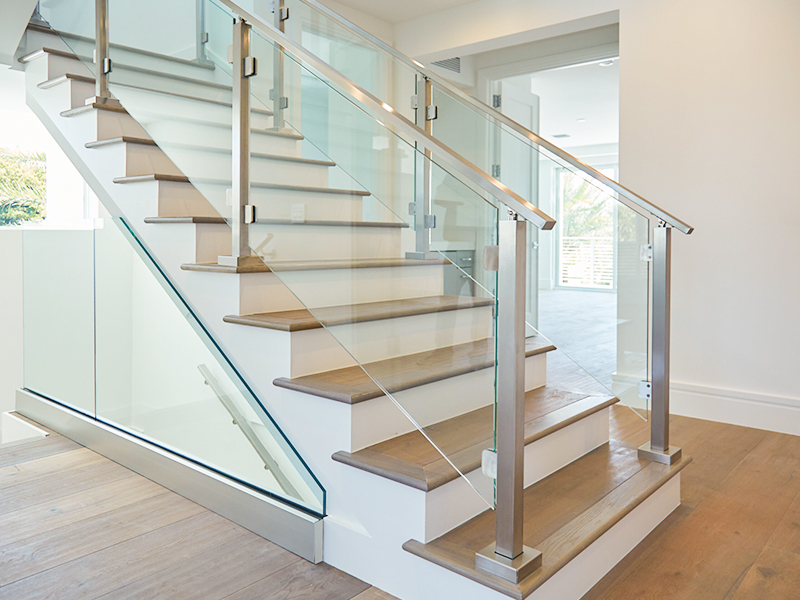Clear glass balustrade staircase with stainless steel handrail.