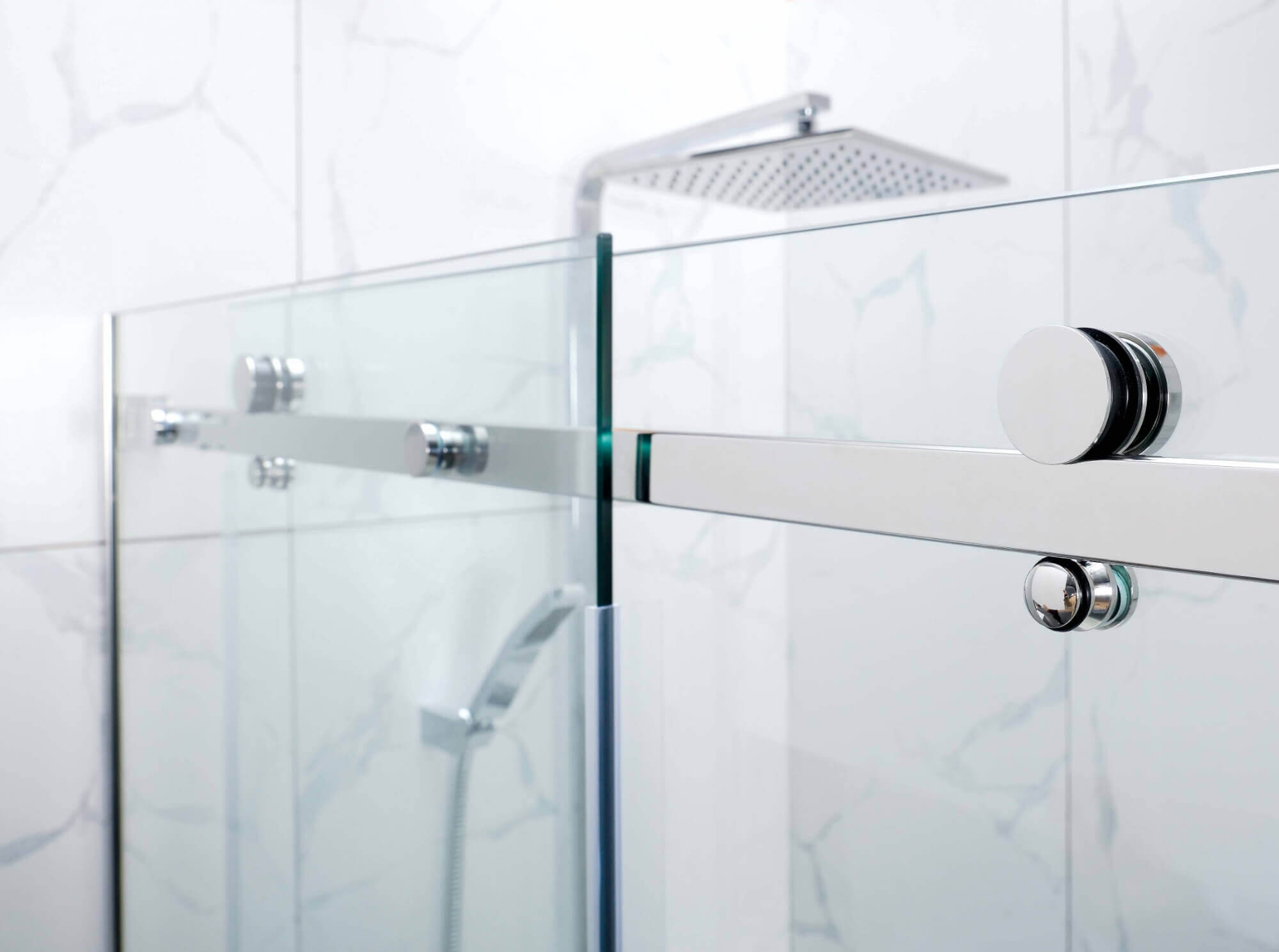 Stainless steel fittings on bathroom glass door.