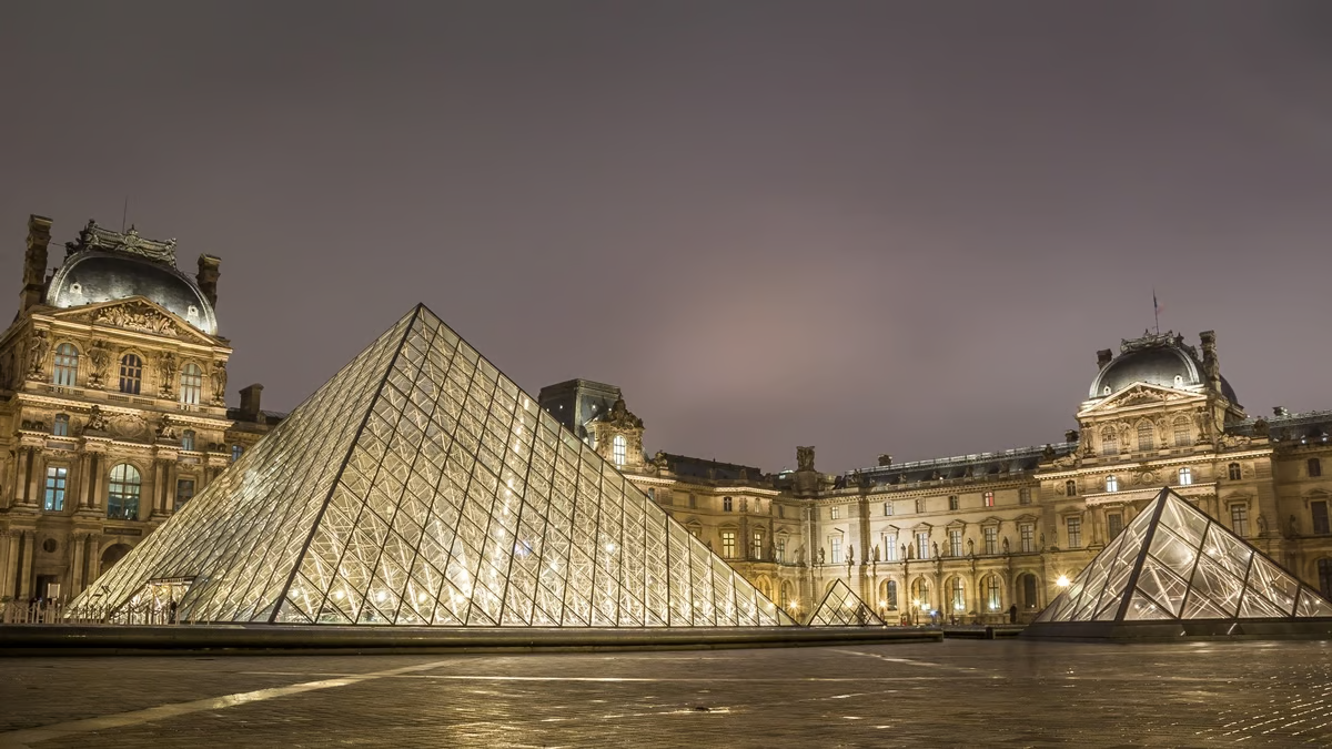 The Louvre Pyramid with stainless steel structures at night.