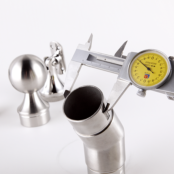 Measuring the diameter of a stainless steel orifice next to two stainless steel fittings.